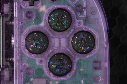 Close-up of a purple joycons with party black buttons installed. Black and rainbow confetti