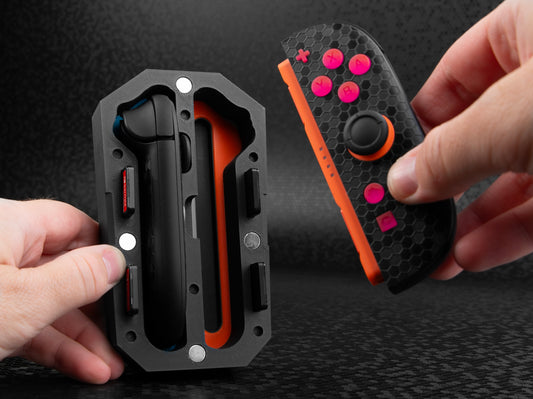 Hand holding a joy pod case inserting a joy con 2