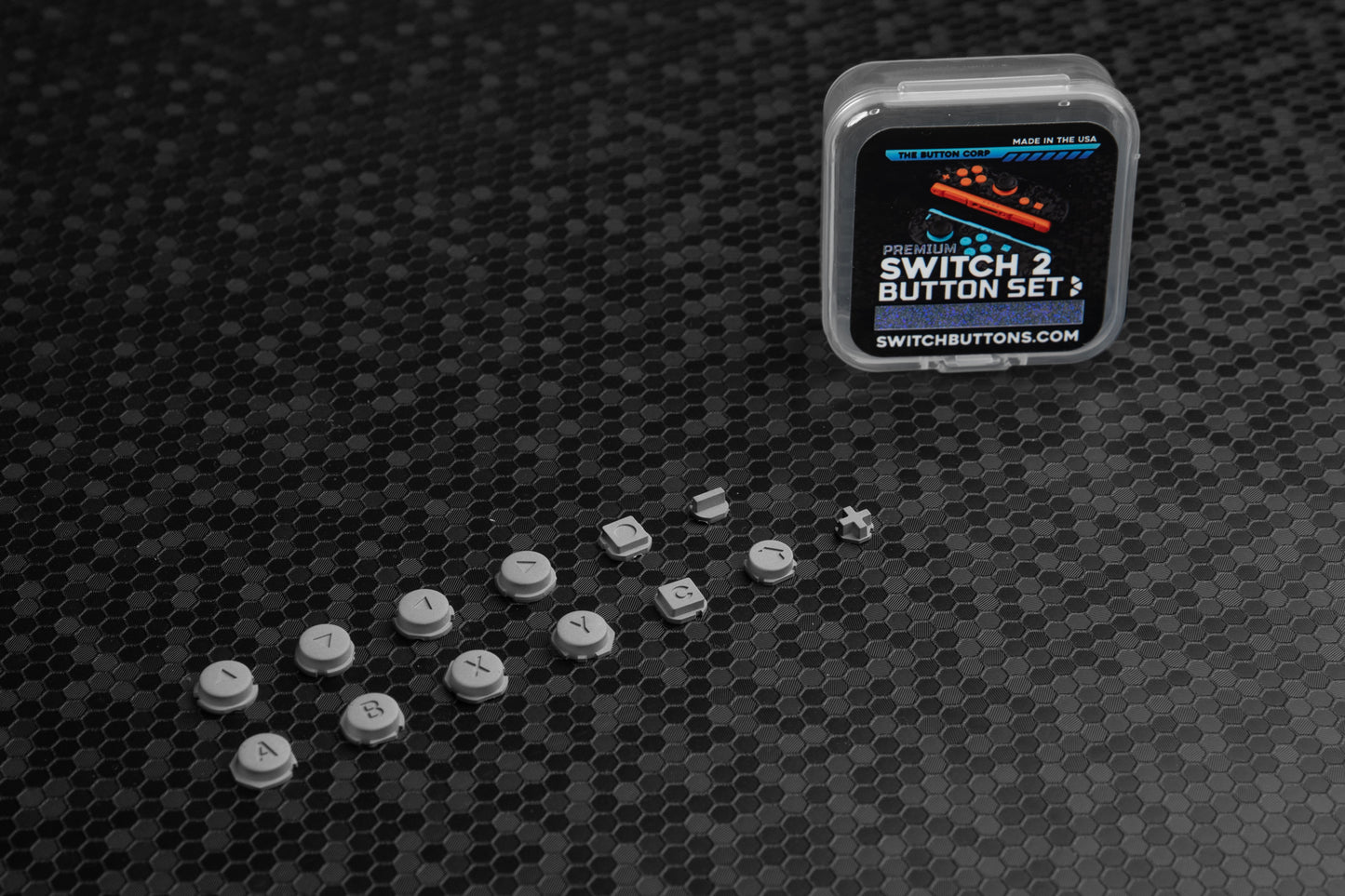 Set of aluminum switch buttons with packaging on a textured black surface