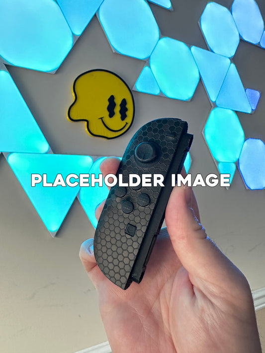 Hand holding prototype joycon 2 with touchprotect installed 