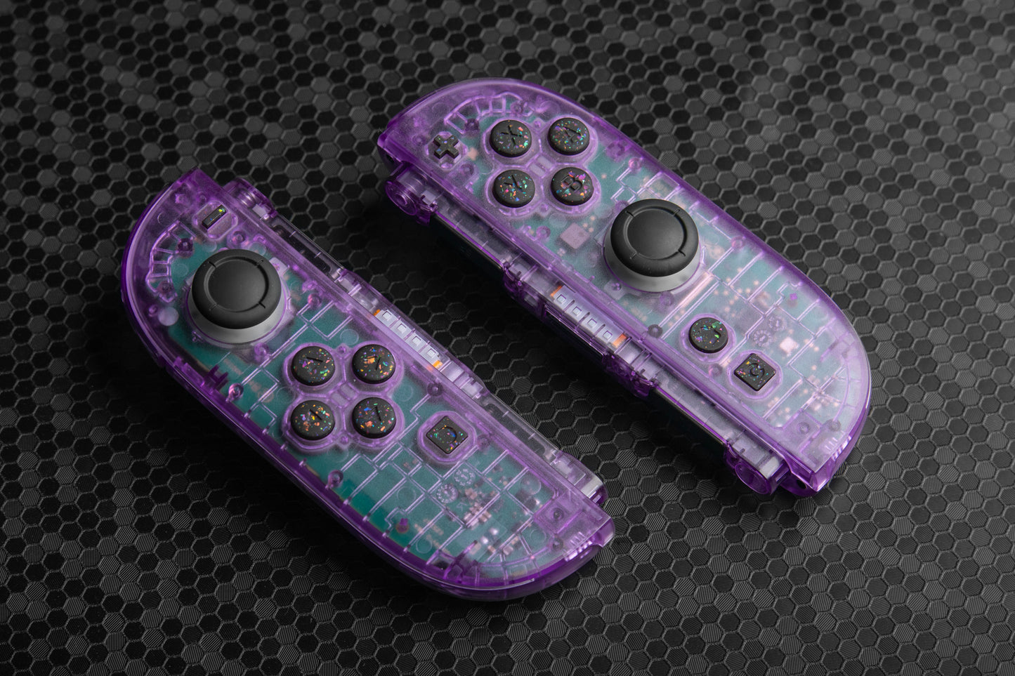 Purple joycons with colorful black buttons on a dark background
