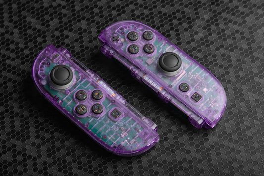 Purple joycons with colorful black buttons on a dark background