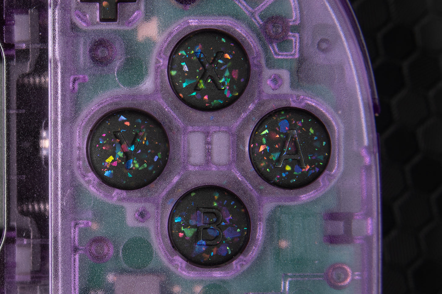 Close-up of a purple joycons with party black buttons installed. Black and rainbow confetti