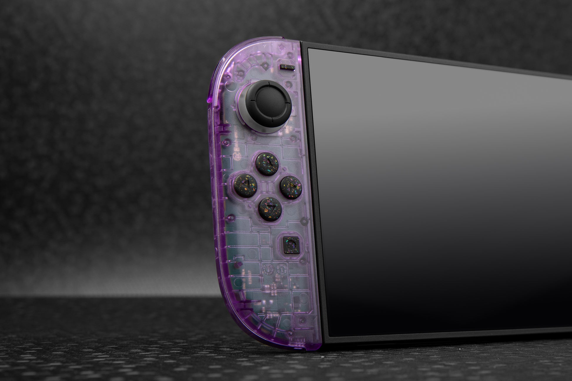 Switch 2 with clear purple joycon installed. Black rainbow confetti buttons installed. 