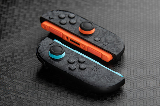 Two Joycons with "oil slick" touchprotect skins installed